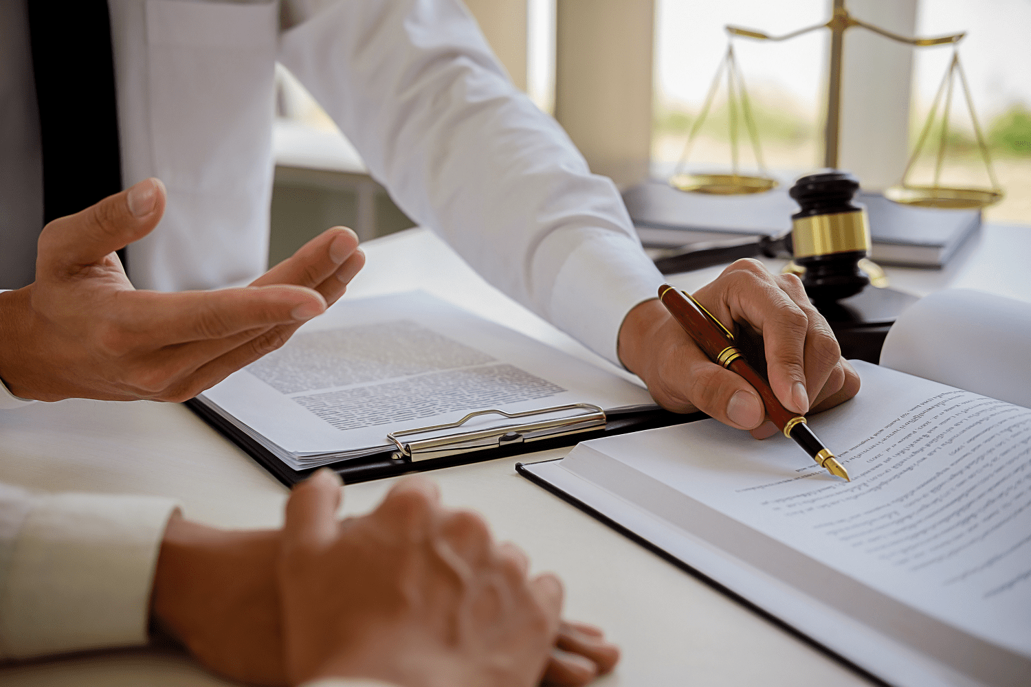Lawyer reviewing legal documents with client