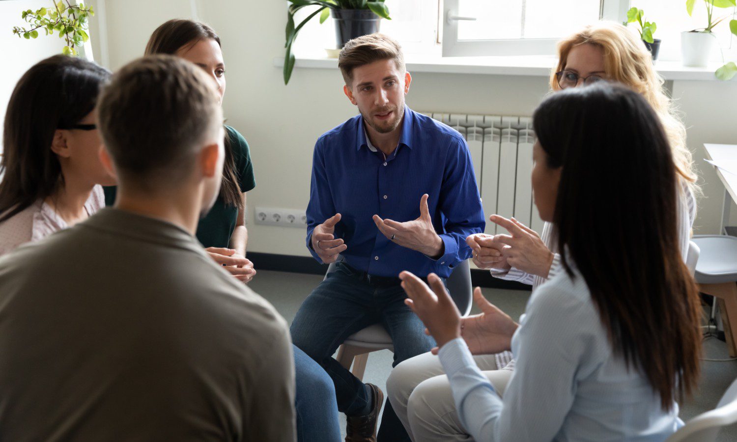 Support group discussion with facilitator speaking
