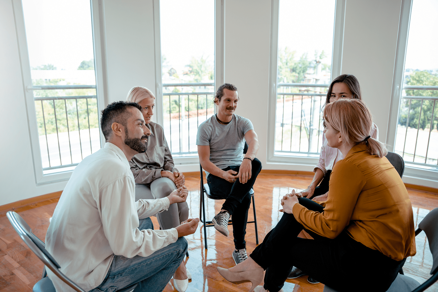People seated in a small group discussion