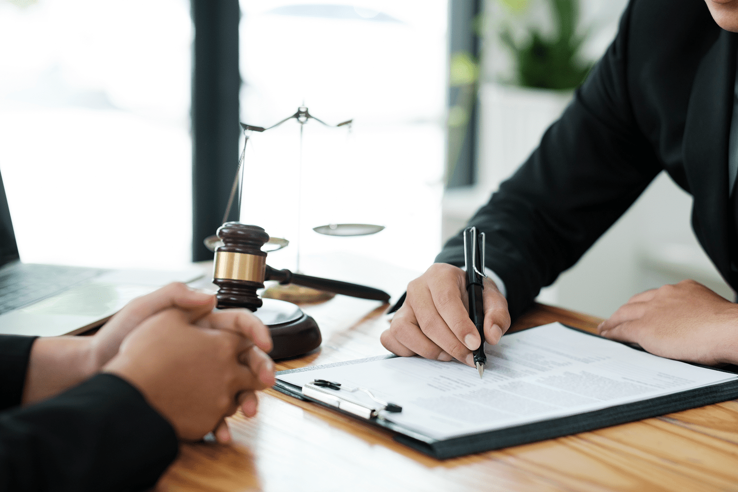Lawyer signing legal document with gavel