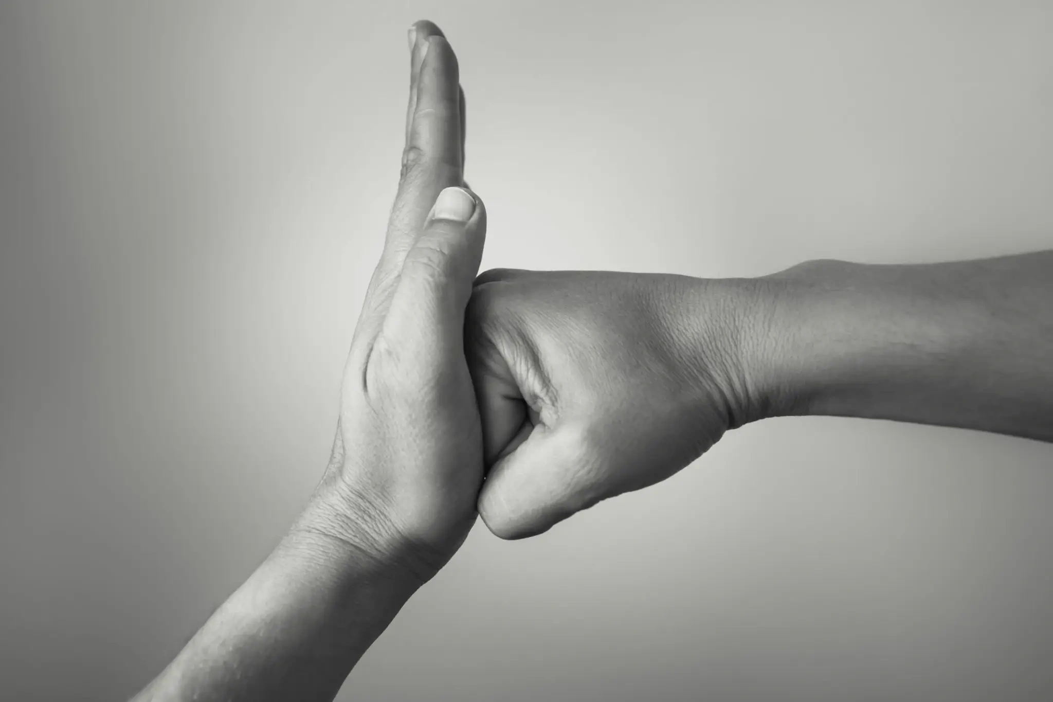 Open hand blocking a fist