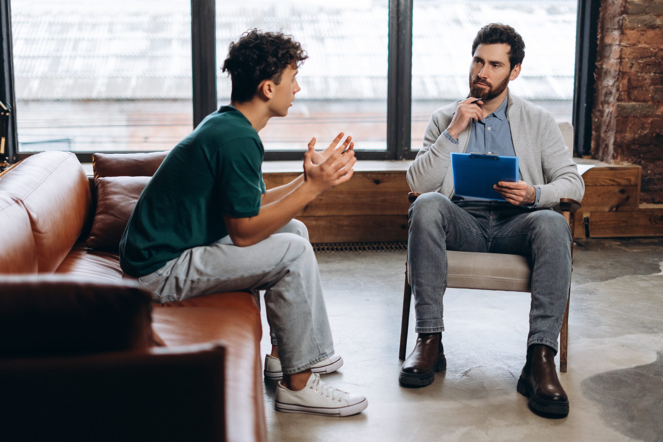 Counselor listening to client during therapy session