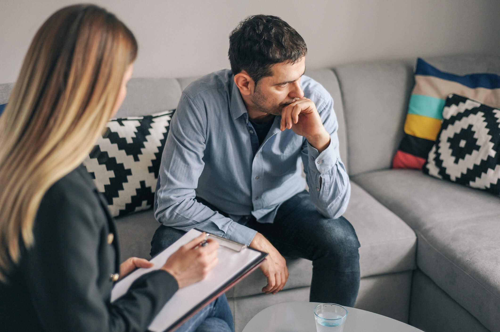 Therapy session: worried man and counselor