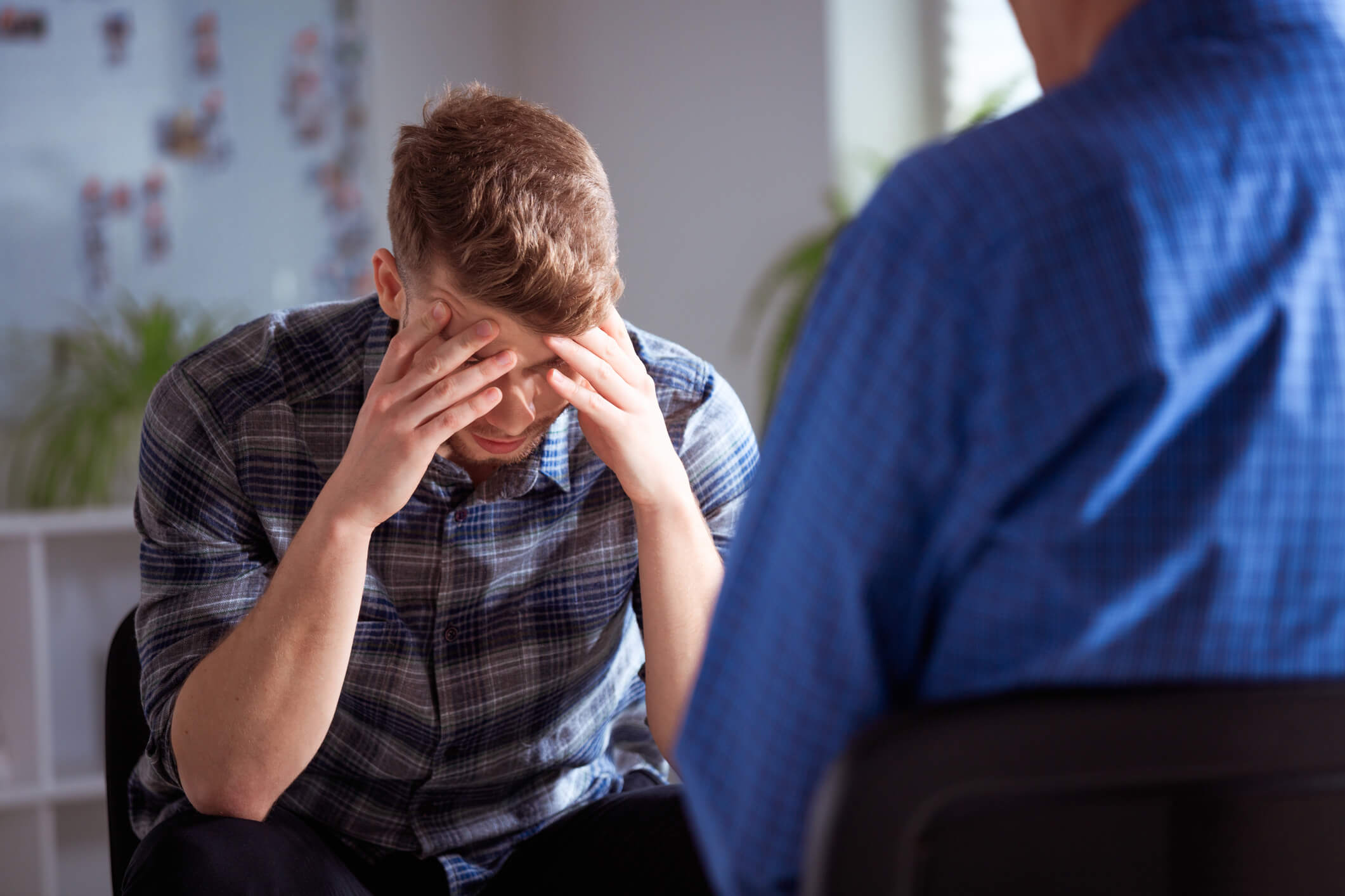 Stressed young man in counseling session
