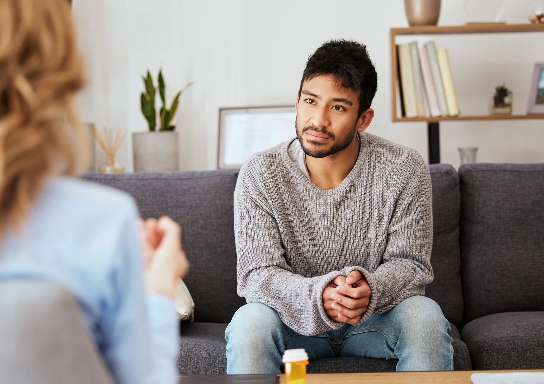 Young man in counseling session on couch