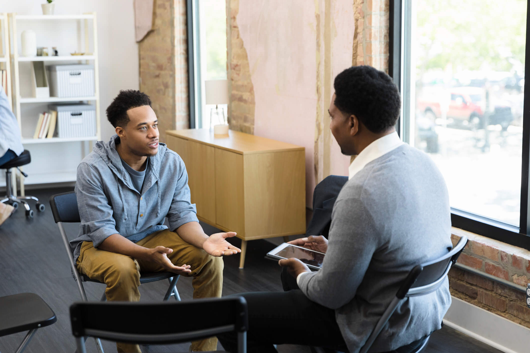 Two people conversing in a modern office