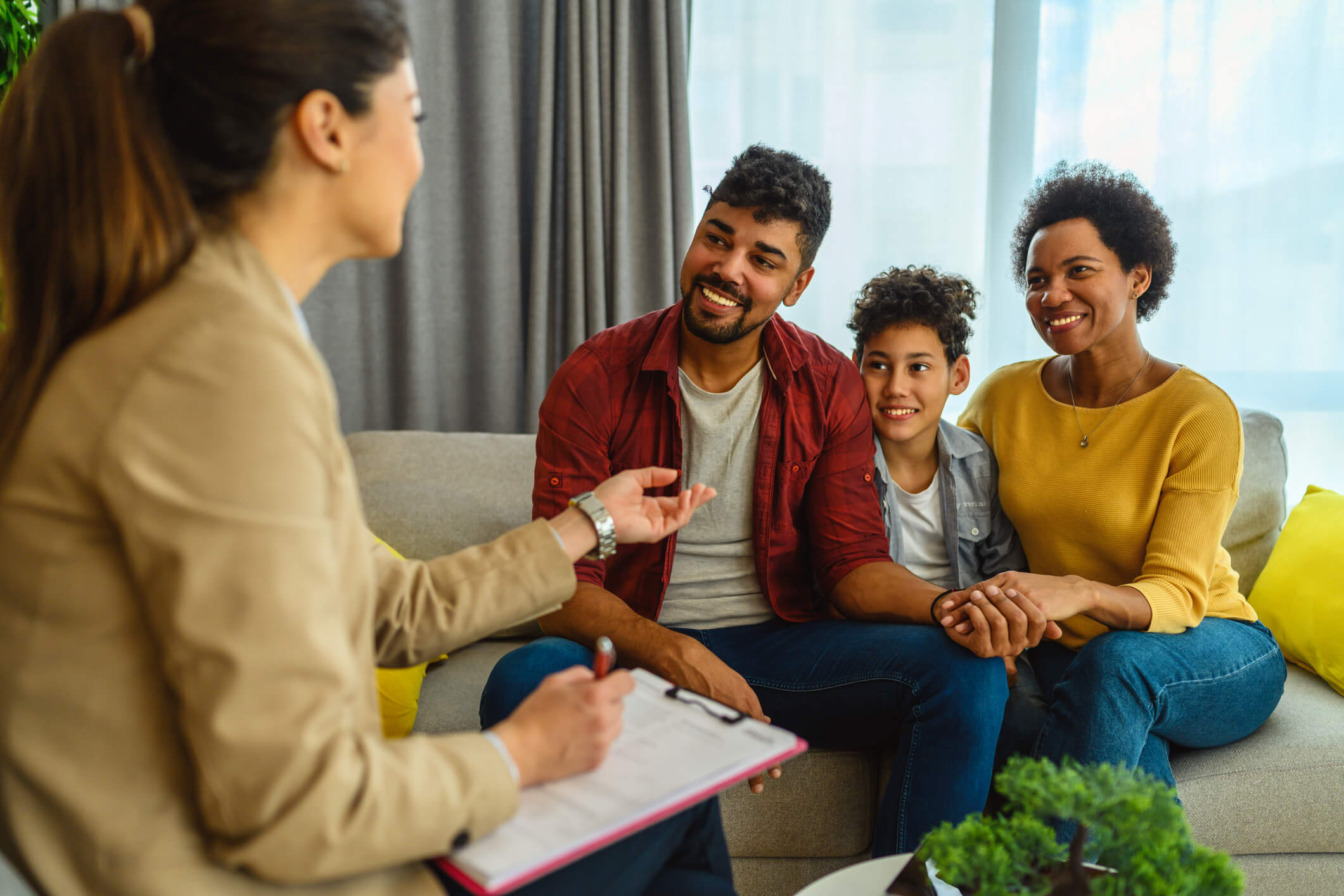 Family meeting with counselor on living room sofa