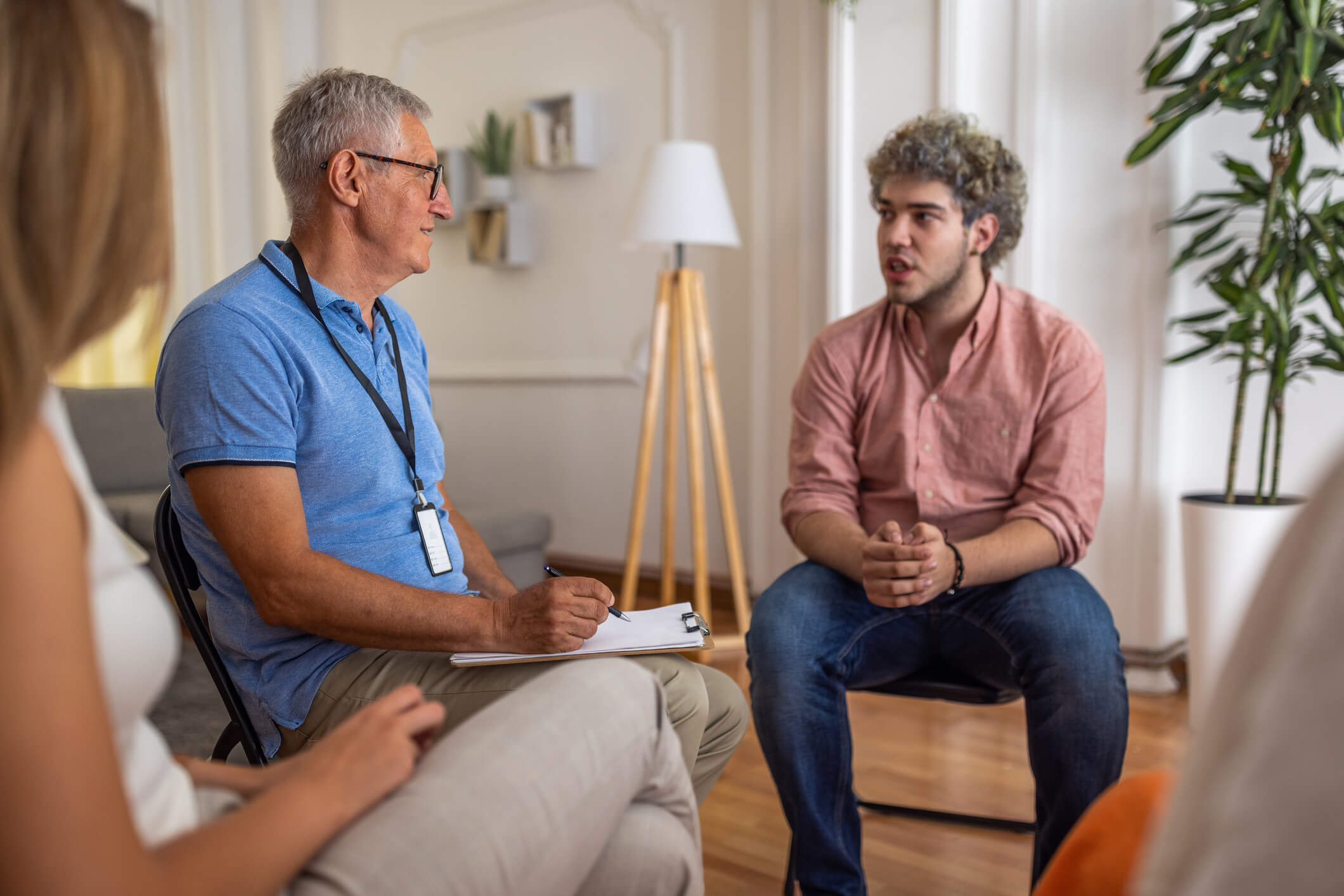 Group therapy session with counselor and participant