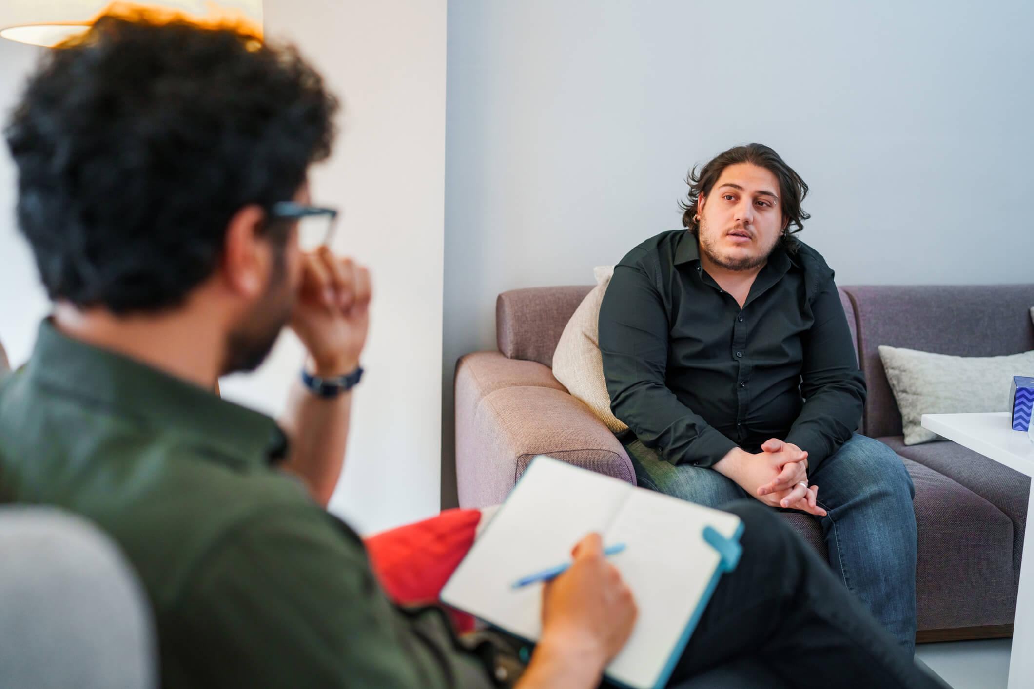 Therapist taking notes during counseling session1