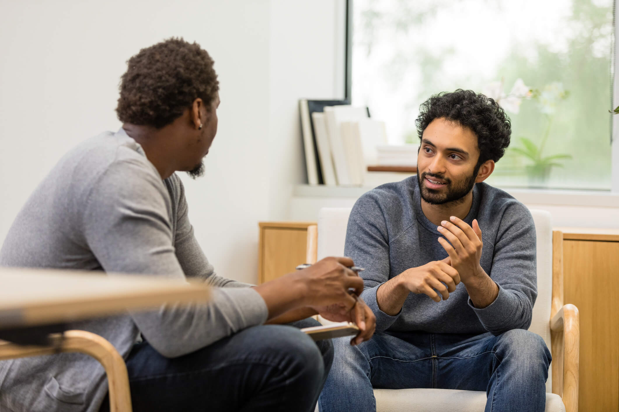 Two men conversing in a living room