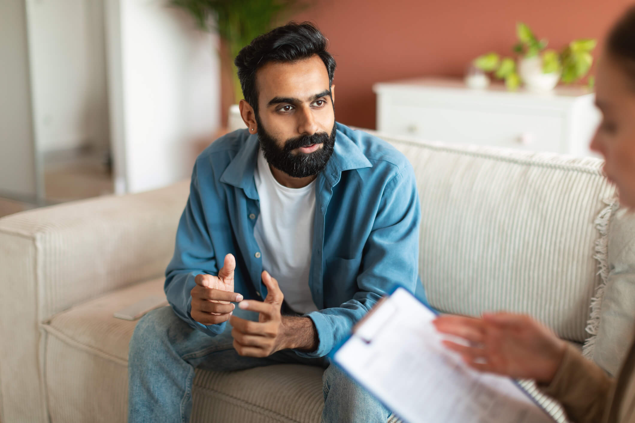 Man talking with therapist on a couch
