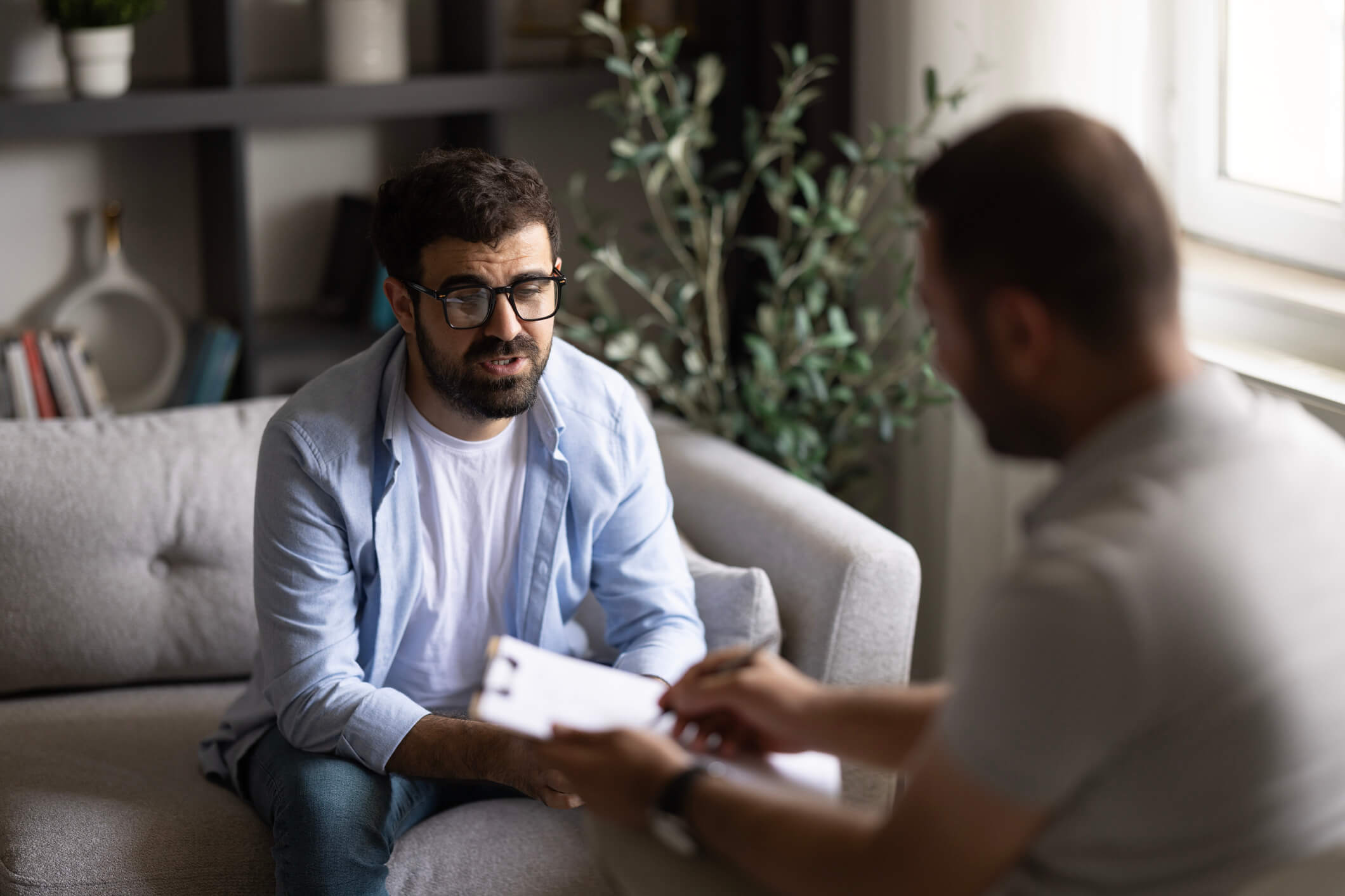 Two men conversing in a casual office setting