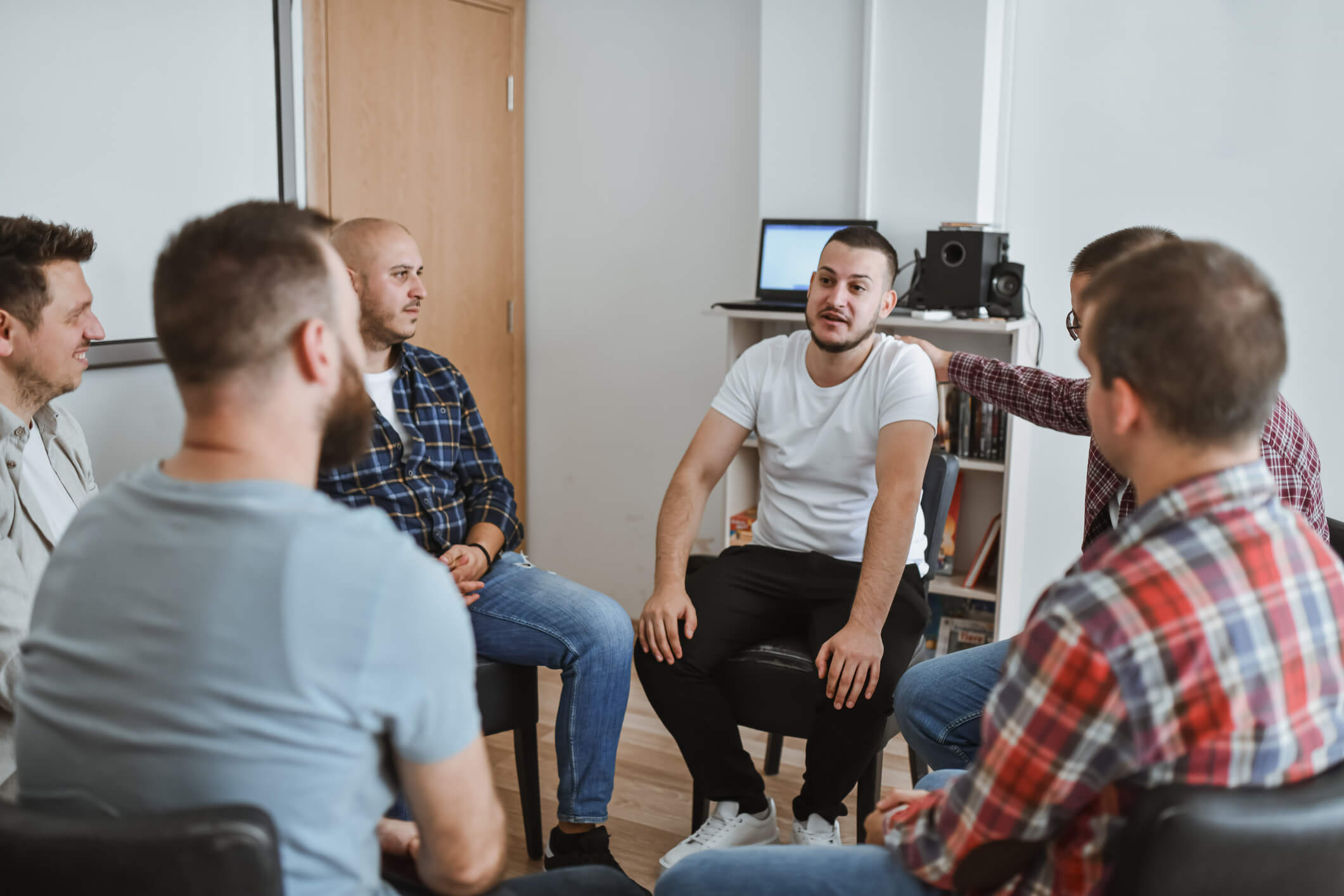 Men's support group meeting in circle