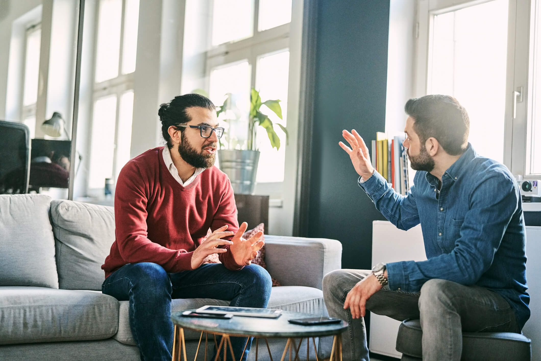Two men talking in a modern office lounge