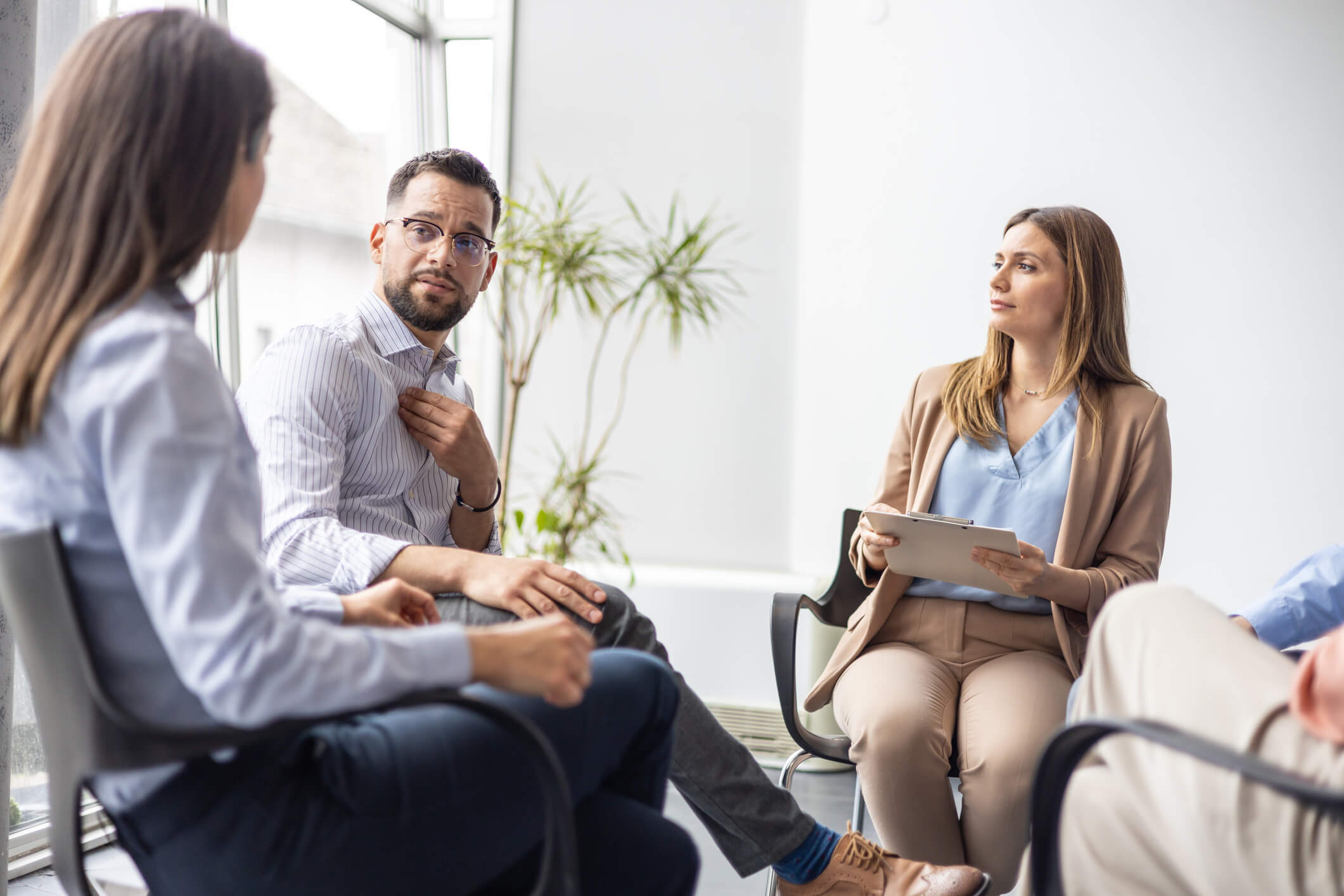 Group therapy session with people in discussion