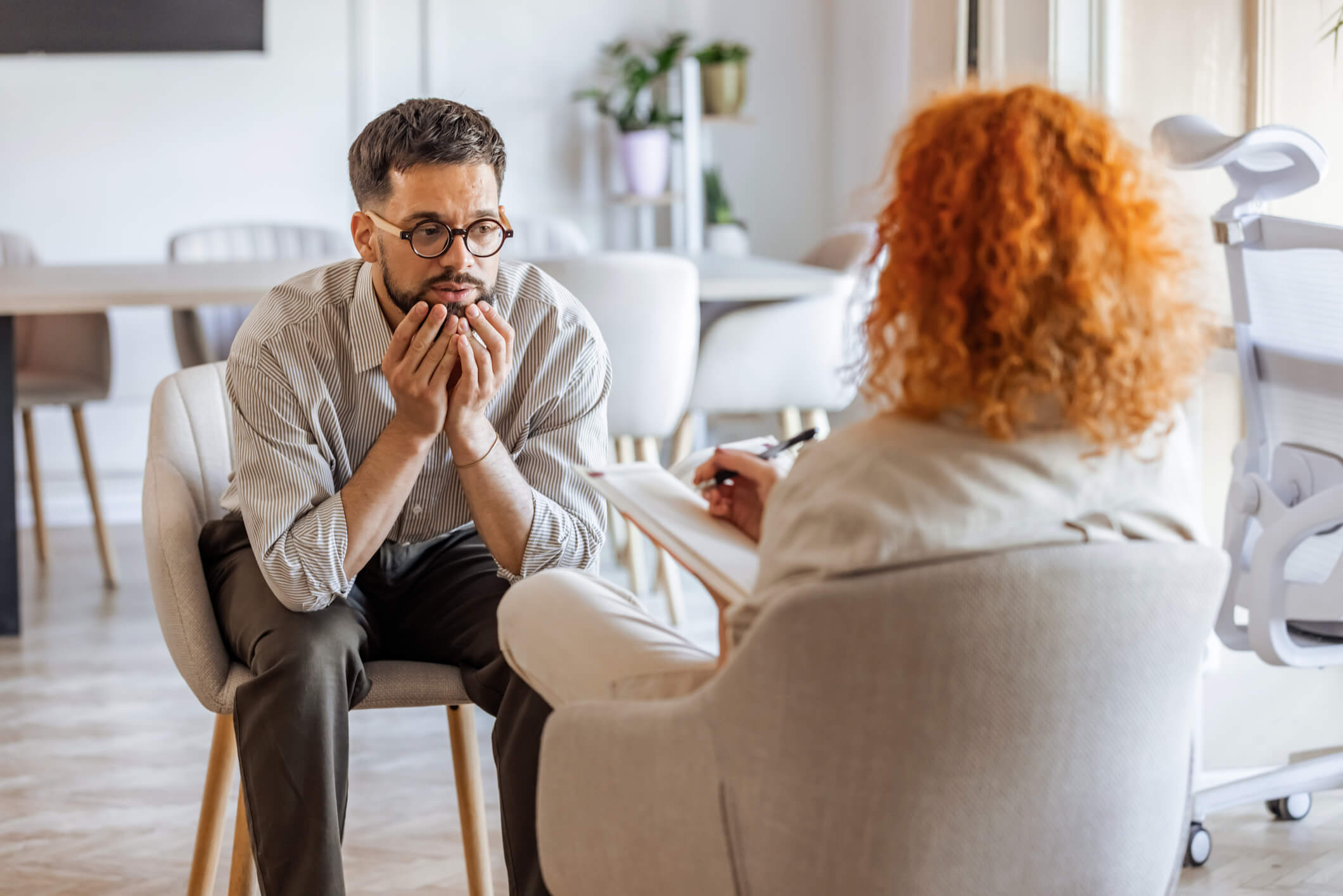 Distressed man in therapy session with counselor